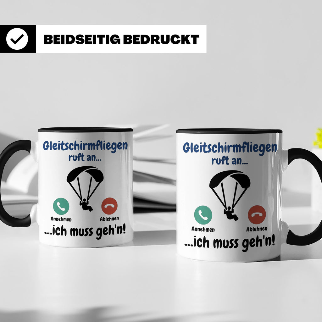 Gleitschirmfliegen Tasse mit Spruch 'ruft an ich muss geh'n' – Schwarz [farbe:schwarz]