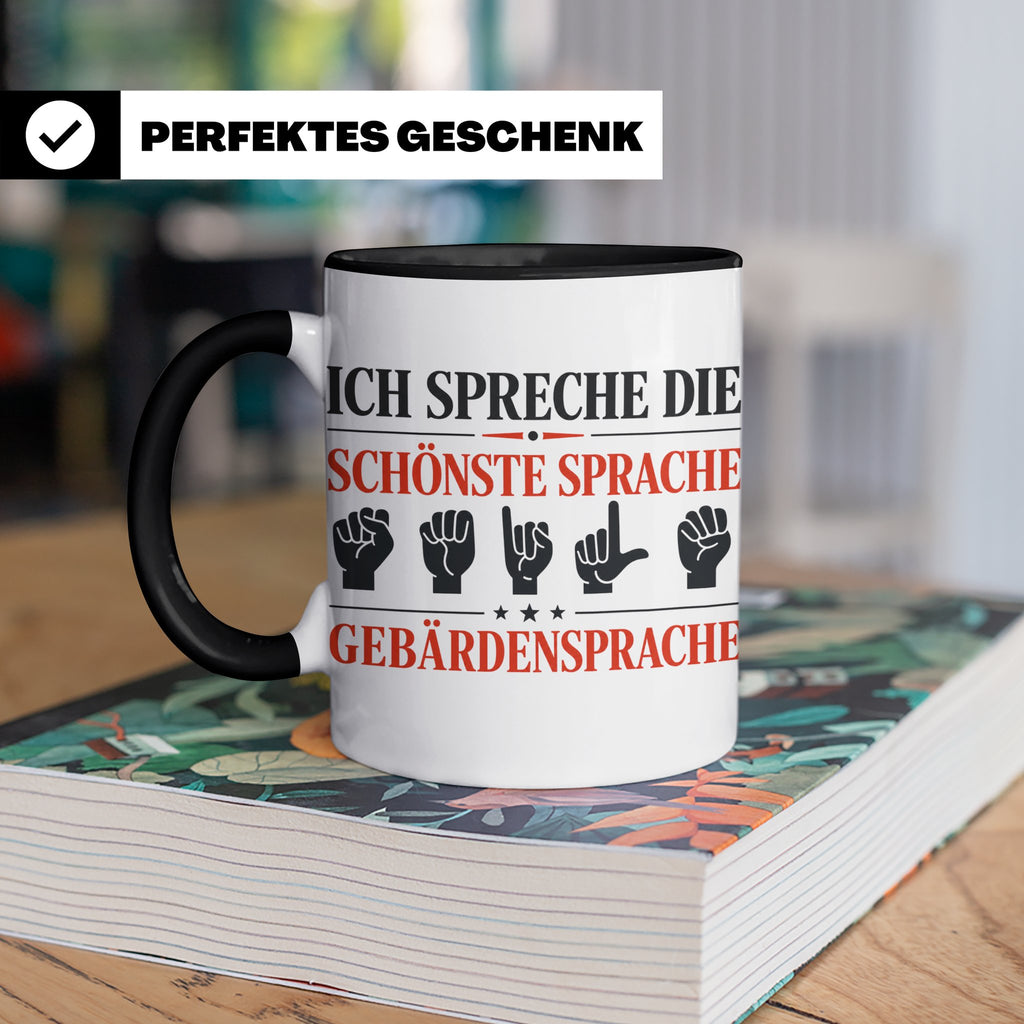 Gebärdensprache Tasse mit Spruch Ich spreche die schönste Sp – Schwarz [farbe:schwarz]